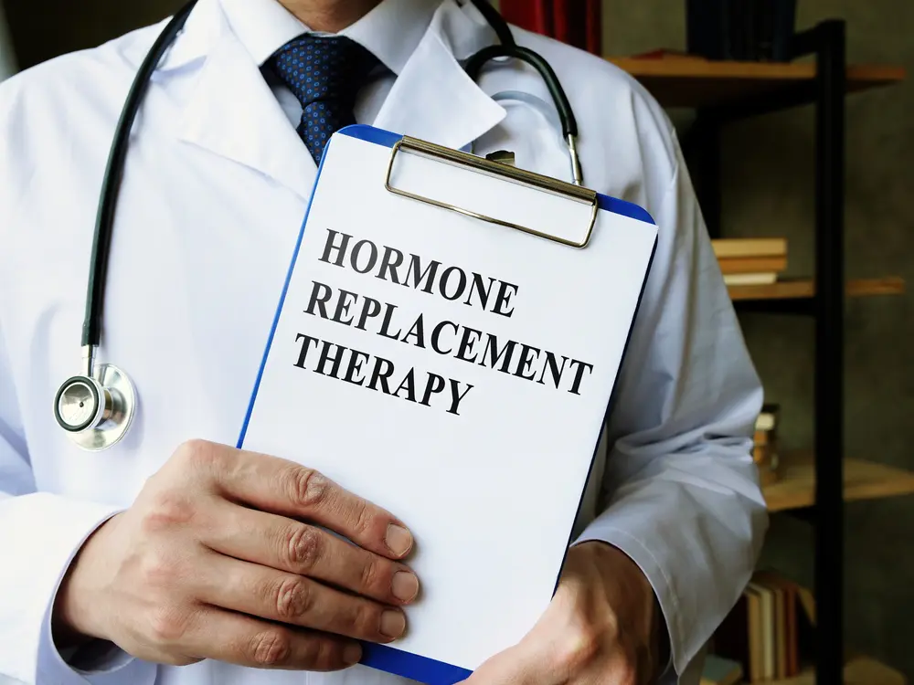 Doctor holding a clipboard labeled 'Hormone Replacement Therapy,' representing the importance of finding local TRT clinics for personalized treatment. If you're searching to find local TRT clinics, expert care can help restore hormone balance and improve overall well-being.