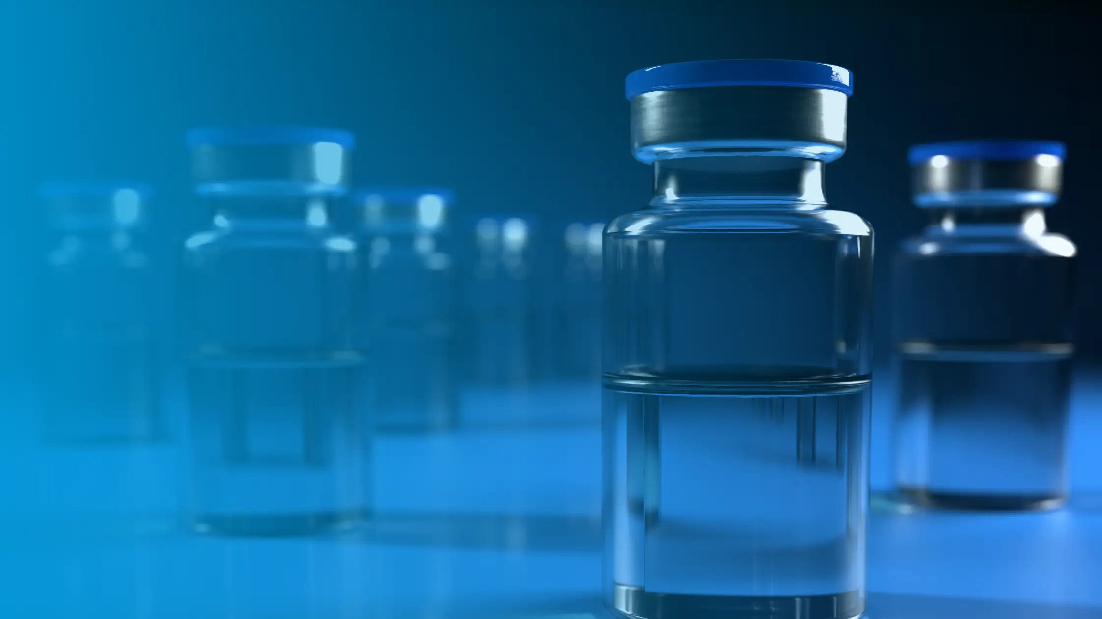 Vials of injectable testosterone medication arranged on a medical surface for hormone therapy treatment